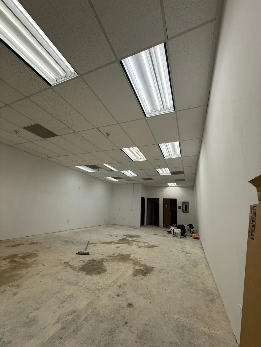 Commercial suite with new ceiling grid lighting during a tenant improvement